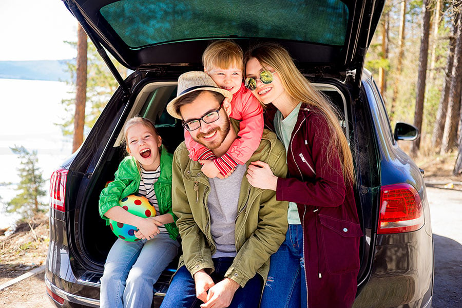 A family gets ready to go on a road trip after choosing an auto loan lender in Wilmington, NC, to purchase their new car.