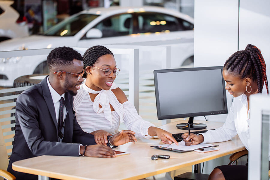 A couple discusses how to refinance an auto loan with an advisor.