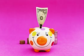 Family saving in a piggybank - isolated over pink